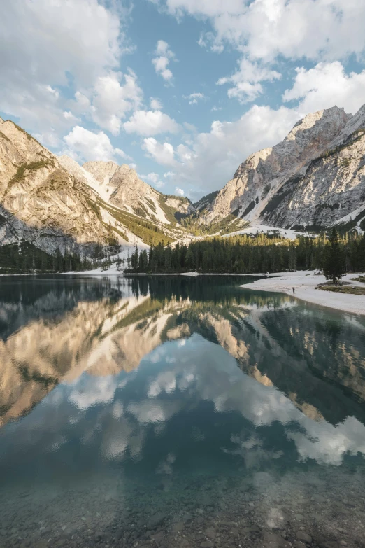 a view of some mountain range with water in the foreground