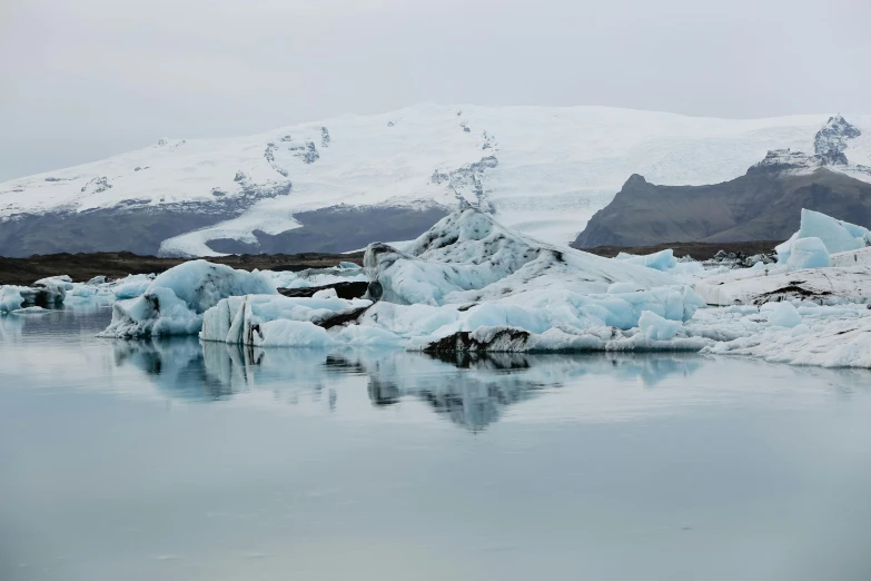 an iceberg in the middle of the water is very large and icy