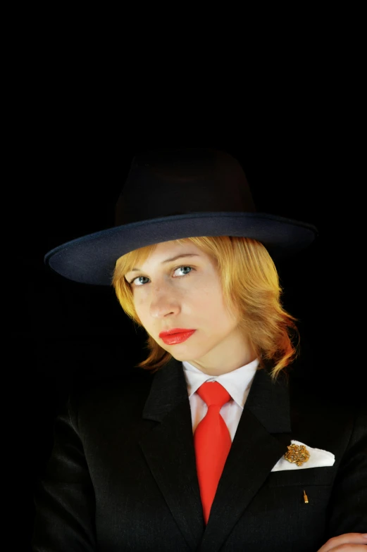 woman in business suit and fedora with hat