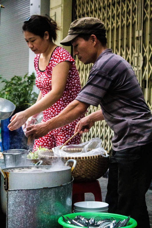 two people are cooking and some plants are growing