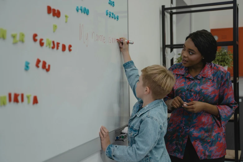 an adult teaching a young child on a board