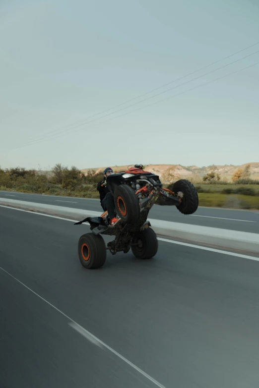 a monster truck driving on the road in front of another