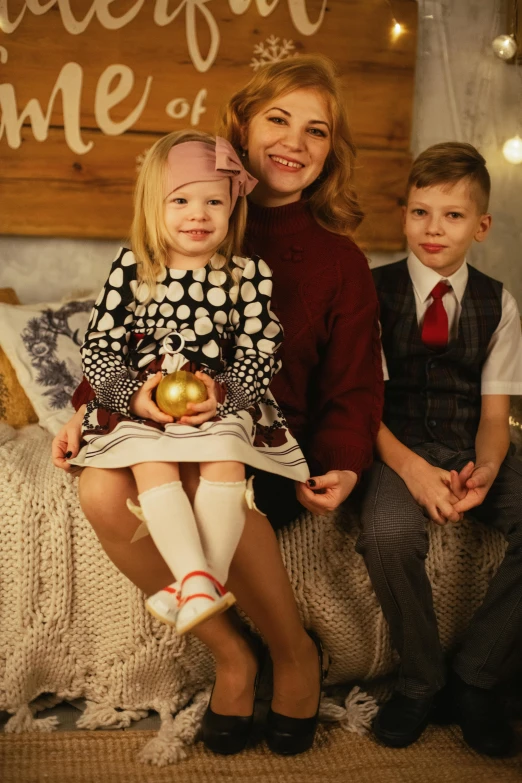 a woman and two small children sitting next to each other