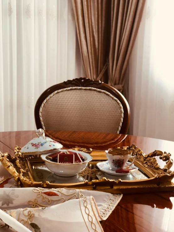 a chair sits at the end of a table with trays on it