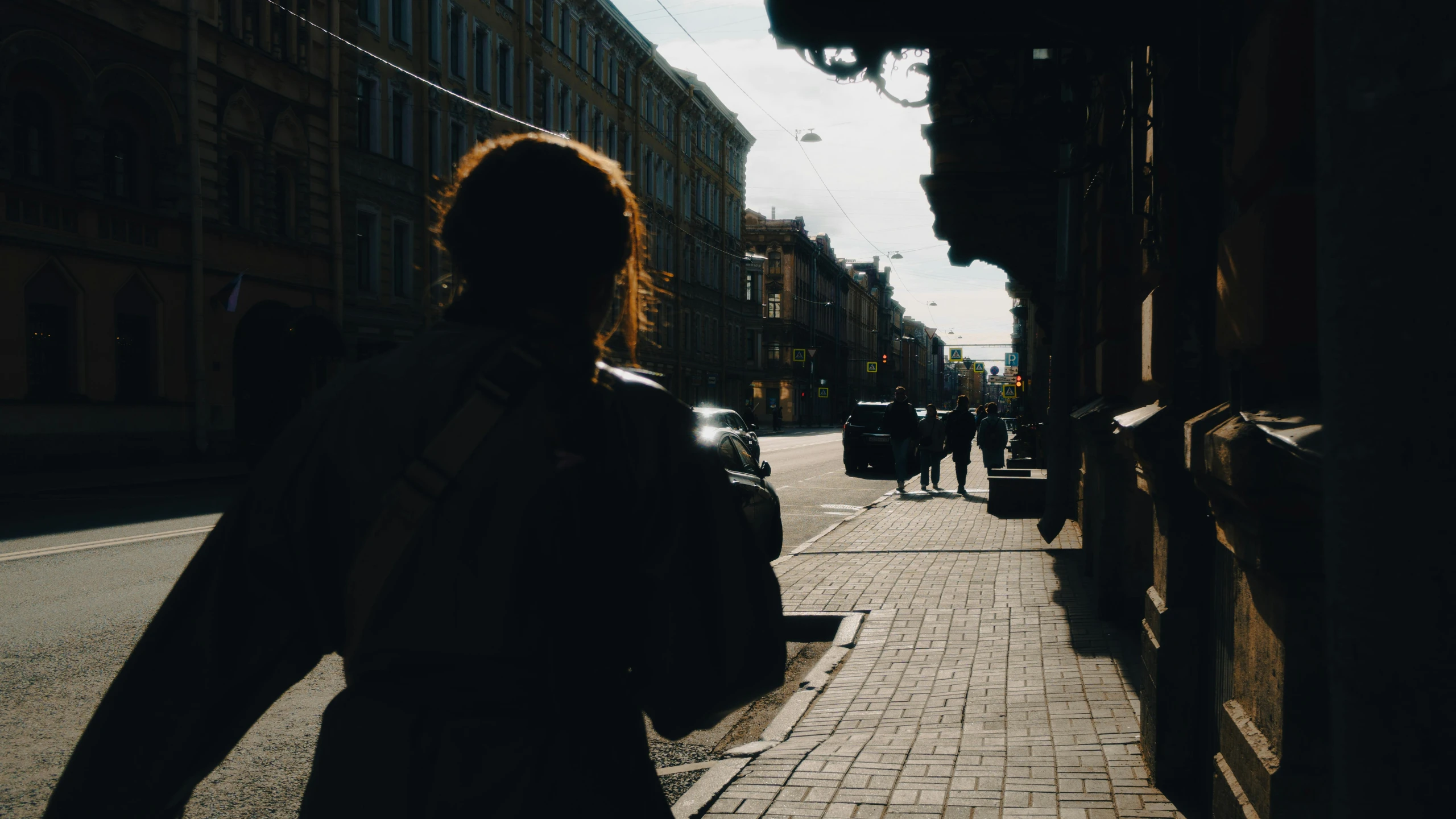 the woman walks down the street on her phone