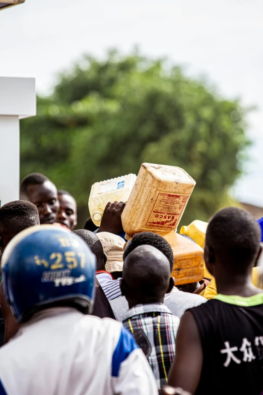 large group of people with one holding a crate