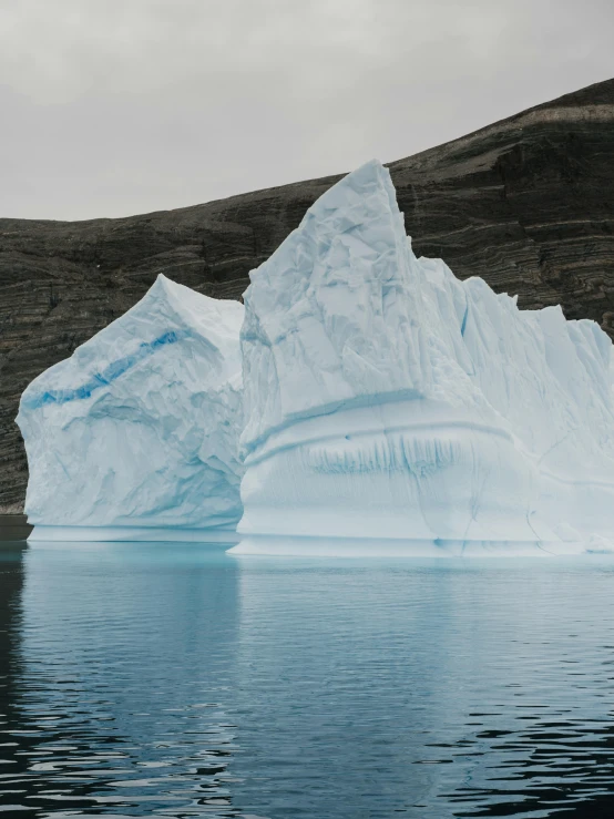 the iceberg is reflected in the water