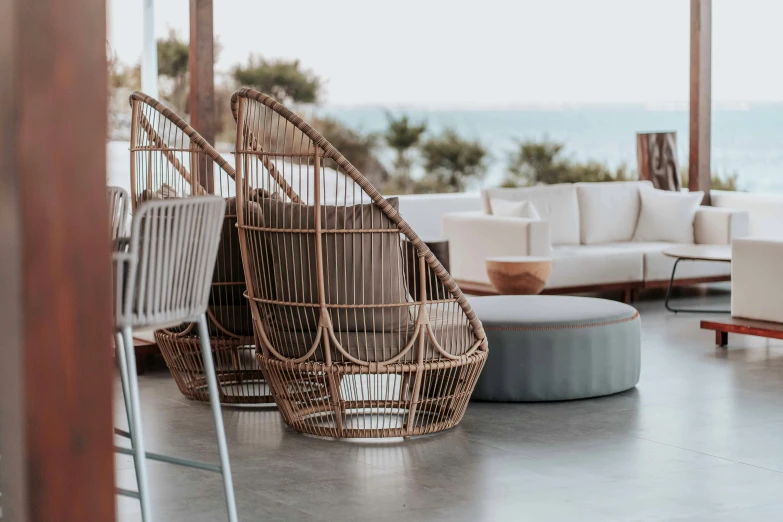 a living room that has white furniture and a view of the beach