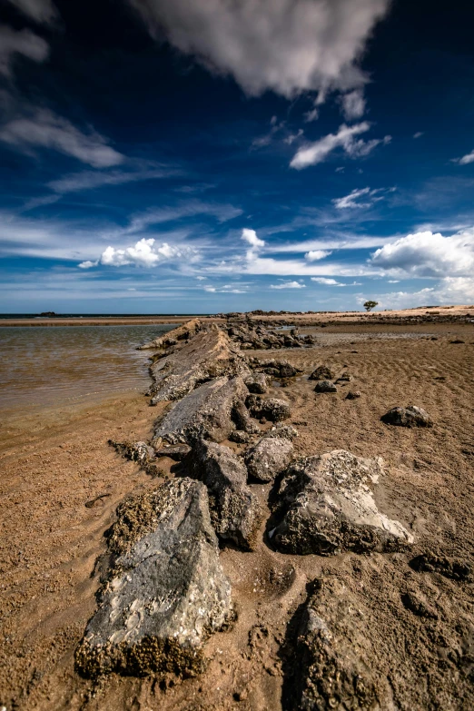 several large rocks along the shoreline of an ocean