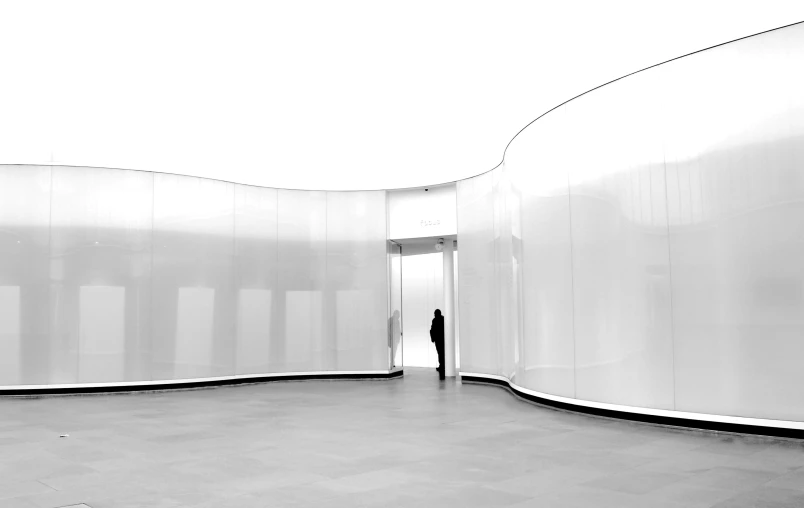 a black and white po of a person in a room with white walls