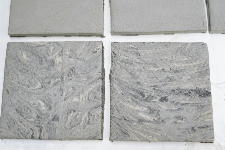 a set of four gray tiles are shown