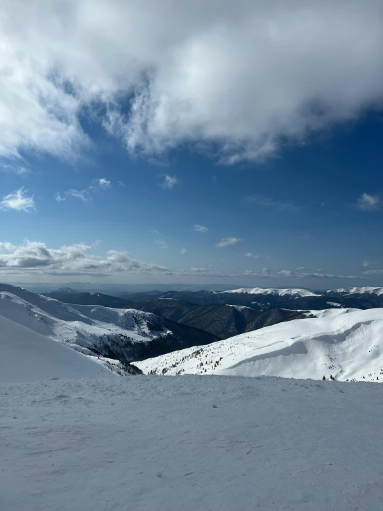 a skier on a mountain in the sun