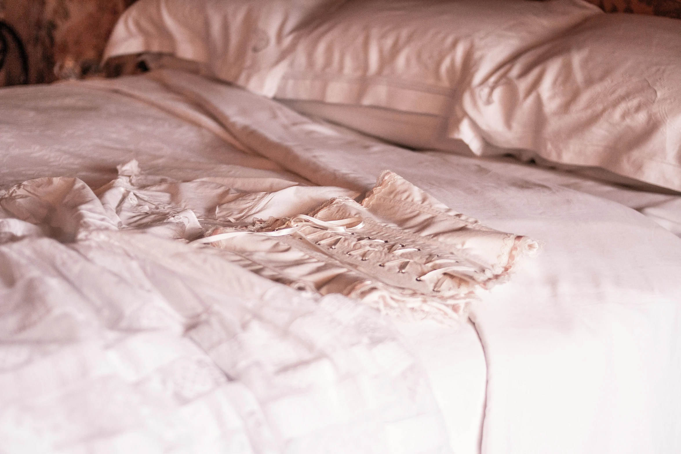 the bed is unmade with white sheets
