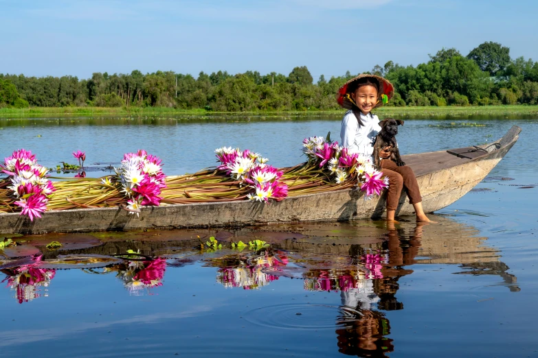 an asian woman sitting in the front of a wooden boat