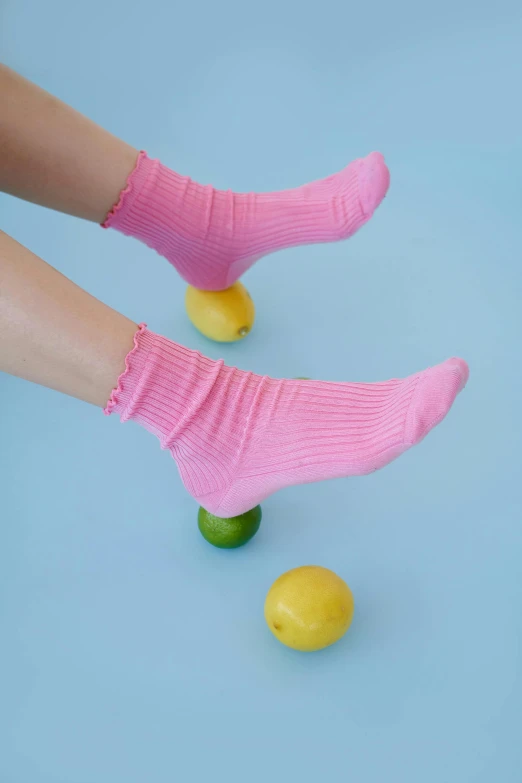 a person with their feet on a toy lemon