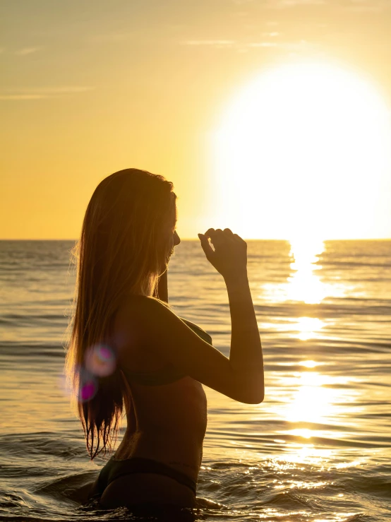 a woman is in the water and posing