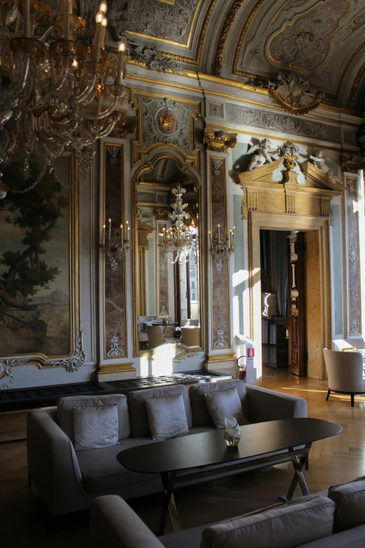 a couch is facing a coffee table in a fancy room