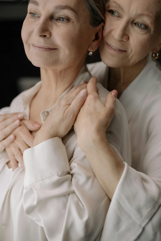 two older women are standing next to each other