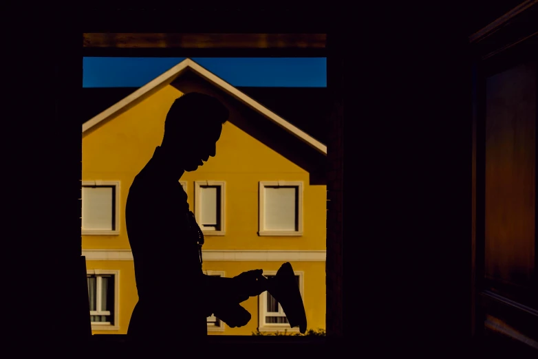 a man looking out a window of a home