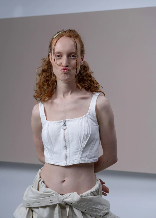 the model is standing on the runway in a skirt