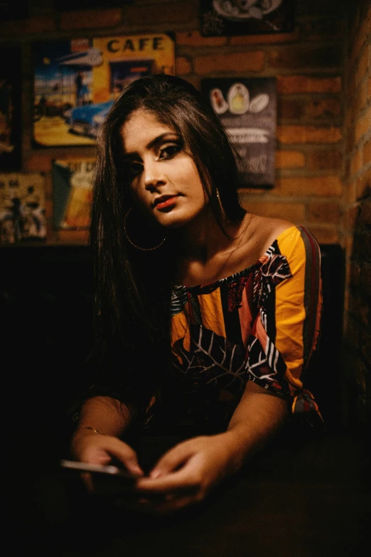 a woman sits and poses for the camera