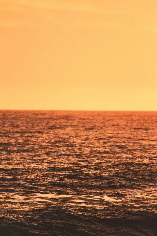 an airplane is flying over a calm ocean