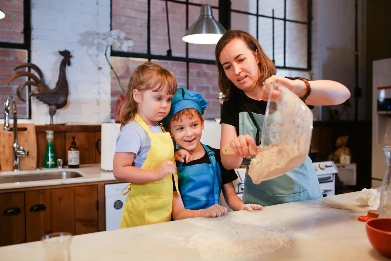 a woman and two children are preparing pie dough