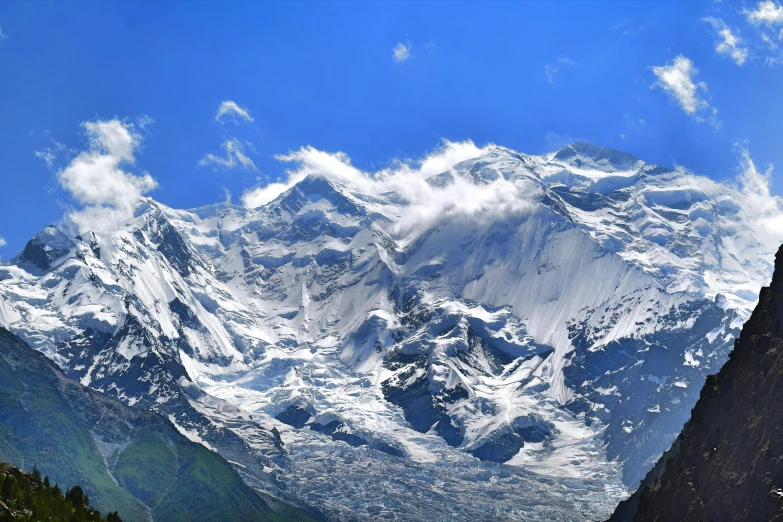 a tall mountain surrounded by lush green trees