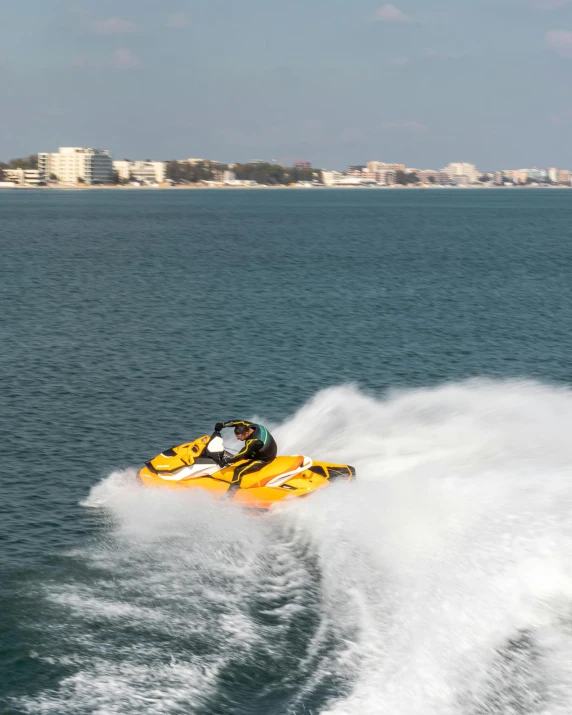 a yellow motor boat speeding through the ocean