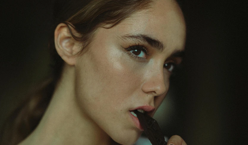 a woman with a toothbrush in her mouth brushing her teeth