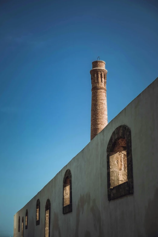 an old stone building has small windows and a tower