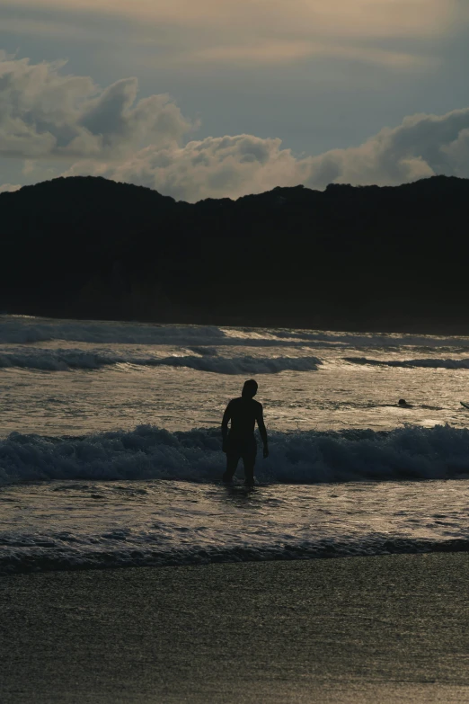 the surfer is coming out from the ocean