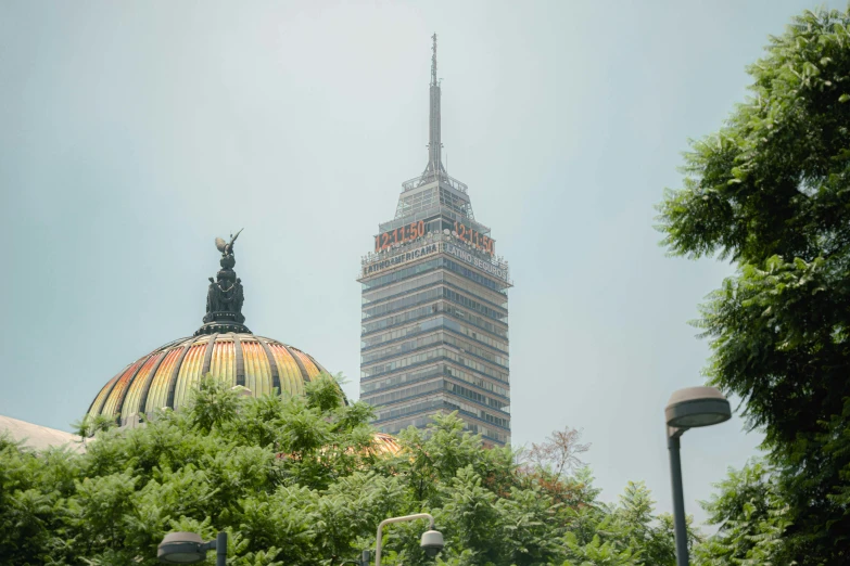 the top of a large building with trees on the foreground