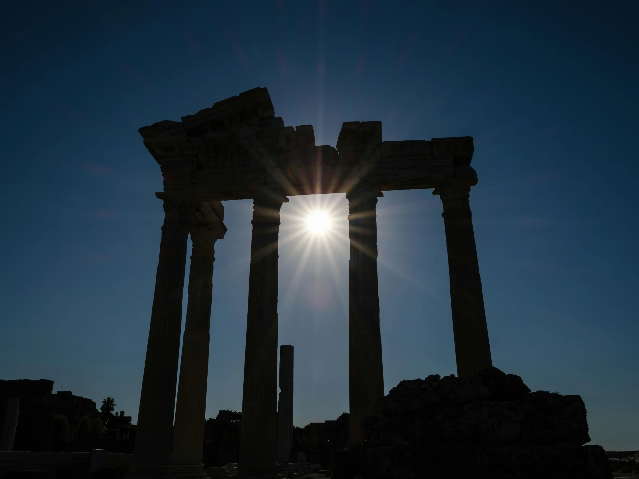 the sun is shining over the ruins of a building