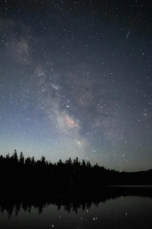 some sky filled with lots of stars near water