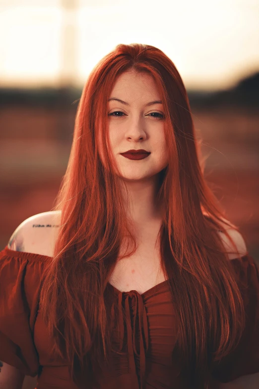 a woman with red hair and a red top
