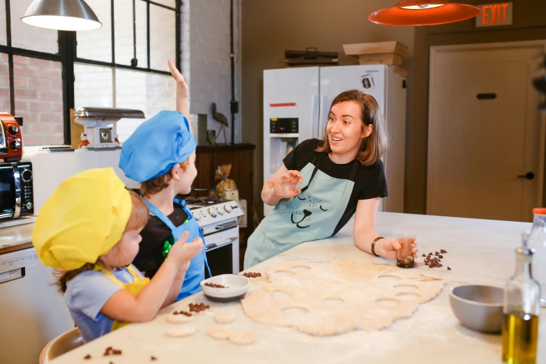 two women and one child are preparing cookies on the counter