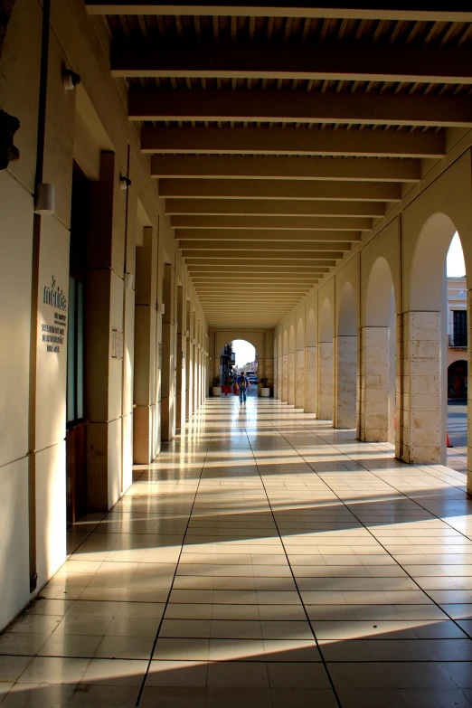 an empty building lined with arches and floor