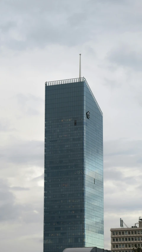 the tall building is next to the boat