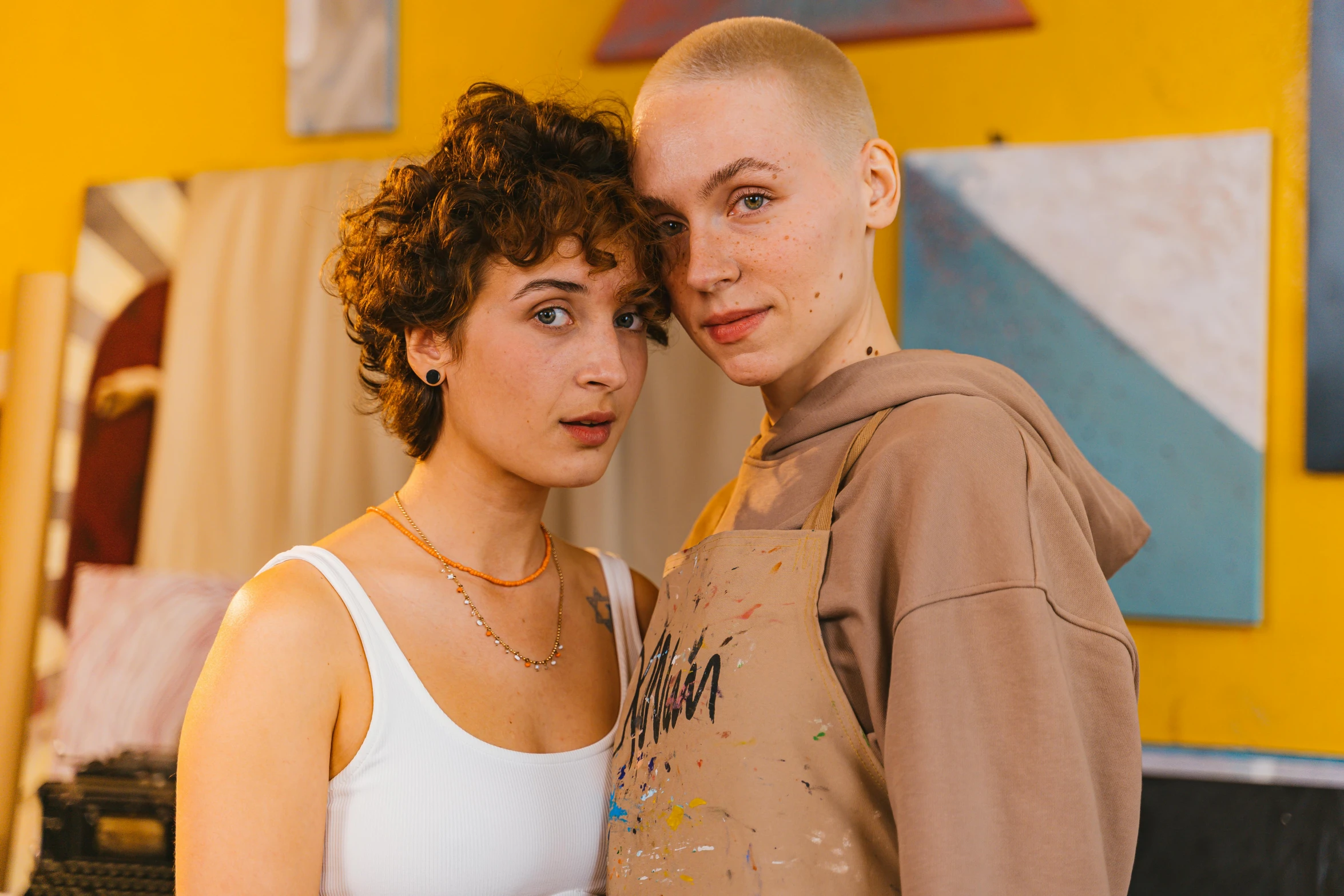 a girl is holding the arm of another woman as they look at the camera