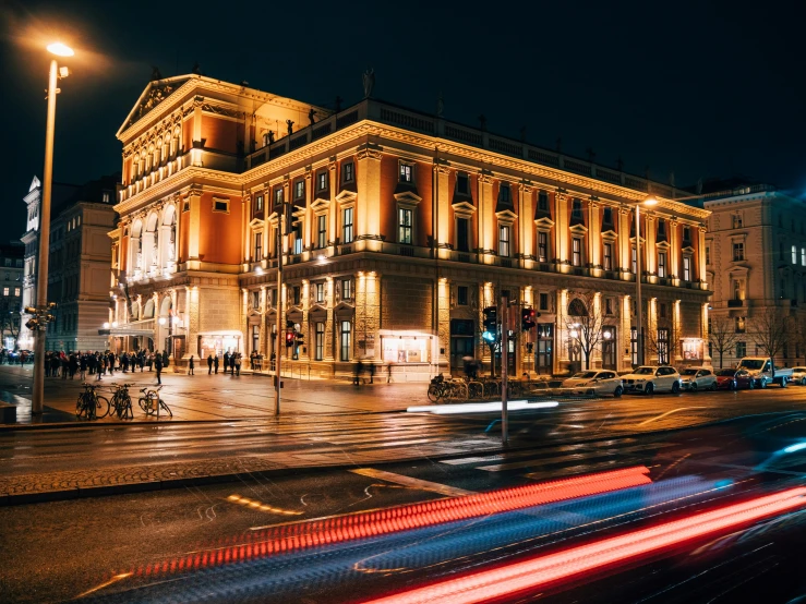 cars are driving through the night on the street