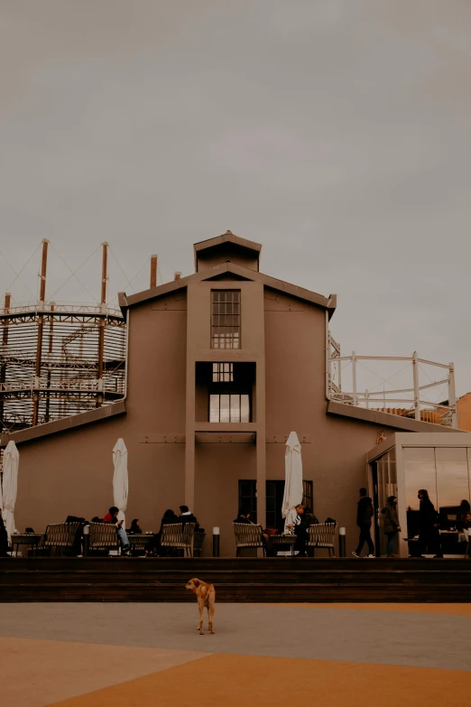 a building is surrounded by many people and a dog