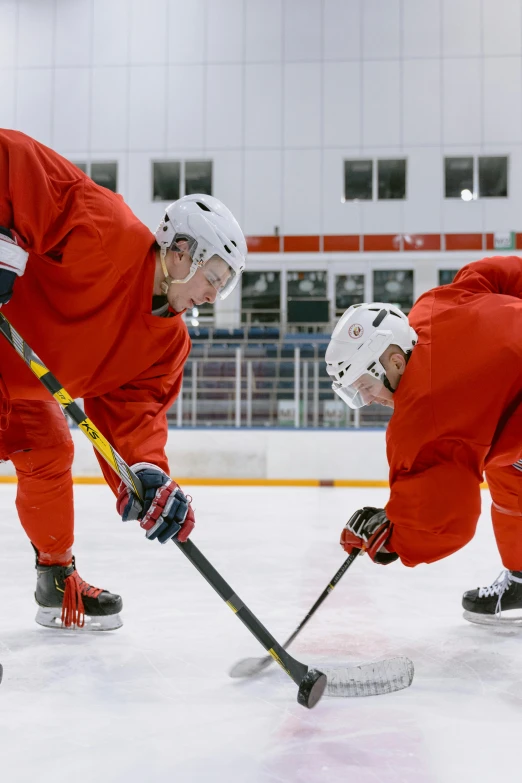 three hockey players are playing on the ice