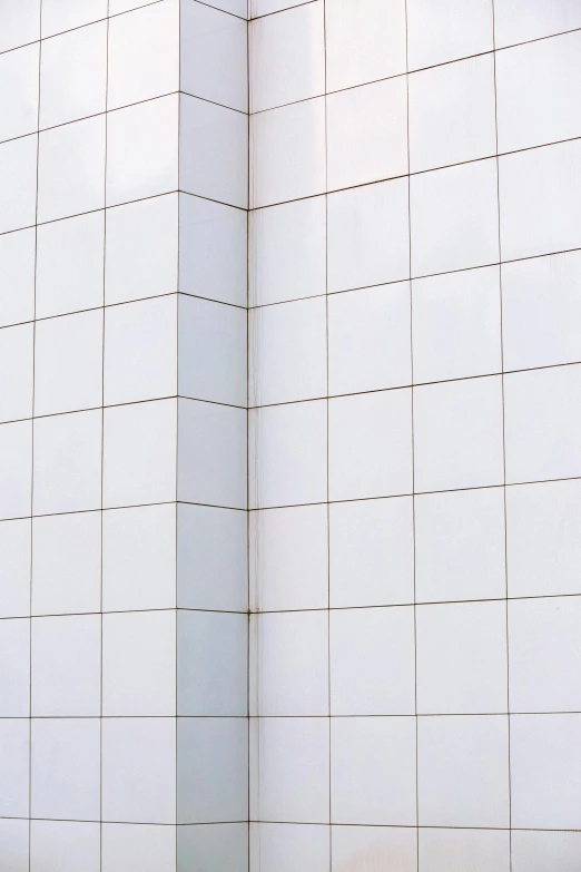 a white wall that has a red fire hydrant in it