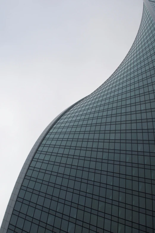 looking up at a very tall building with a clock on the top