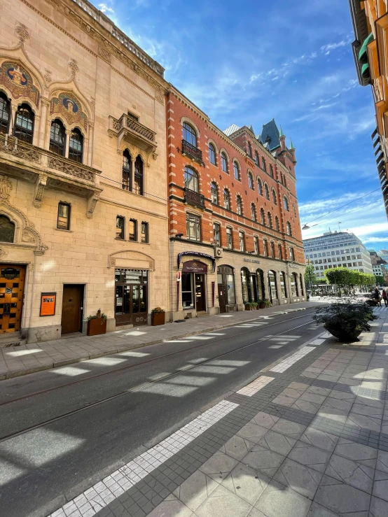 a view of some buildings on the sidewalk