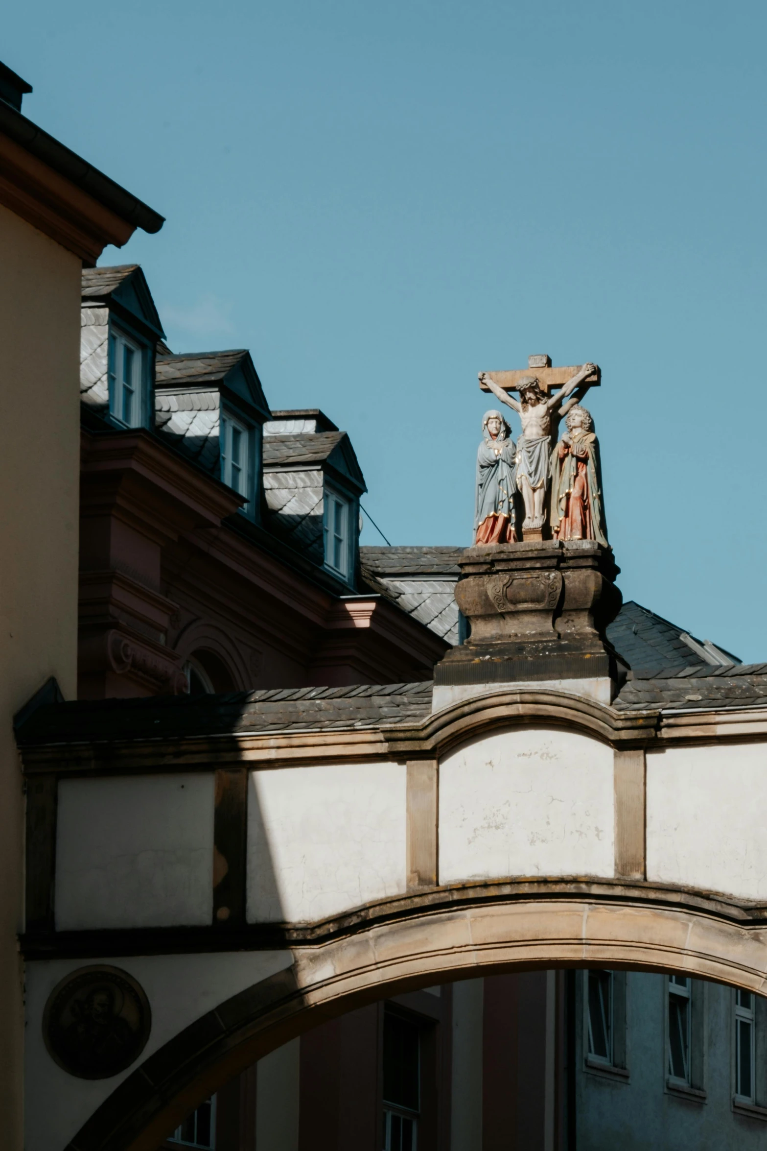 a clock tower with statues on top of it