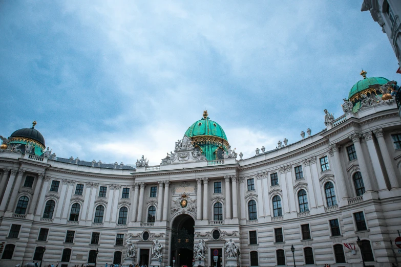 the dome on a building has green decorations