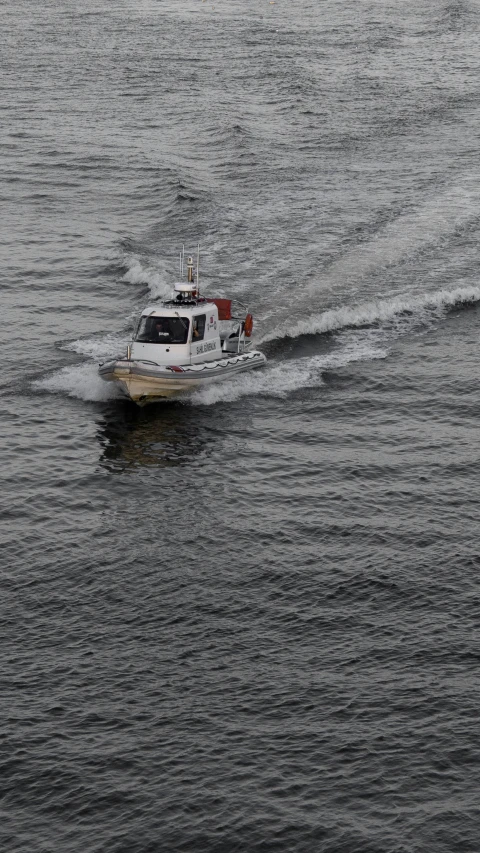 a boat driving across the ocean in a very dark sky