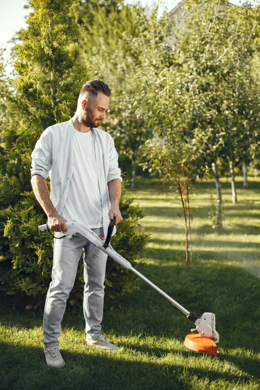 a man mowing grass with a lawnmower